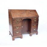 A GEORGE II MAHOGANY KNEEHOLE BUREAU