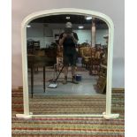 A VICTORIAN LATER WHITE PAINTED ARCH-TOP OVERMANTEL MIRROR