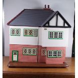 A MID-20TH CENTURY DOLLS HOUSE AND A GROUP OF FURNITURE