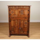 A 17TH CENTURY STYLE CARVED OAK SIDE CABINET ON SLEIGH FEET