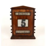 A MAHOGANY PERPETUAL DESK CALENDAR