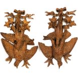 A PAIR OF 19TH CENTURY BLACK FOREST CARVED LIMEWOOD RIBBON-TIED FEATHERED GAME TROPHIES