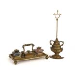 A REGENCY BRASS INKSTAND WITH TWIN GLASS BOTTLES; TOGETHER WITH A VICTORIAN BRASS WEIGHTED...