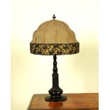 A BRONZE PATINATED METAL TWIN-LIGHT TABLE LAMP