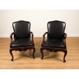 RALPH LAUREN; A PAIR OF CLIVEDON CARVED BRASS STUDDED BLACK LEATHER UPHOLSTERED OPEN ARMCHAIRS...