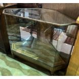 AN OAK AND BRASS BOUND CORNER DISPLAY CABINET