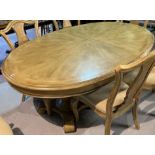 AN OVAL EXTENDING DINING TABLE