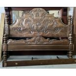 A CARVED HARDWOOD DOUBLE BED