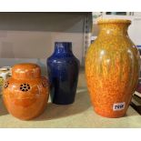 A BLUE RUSKIN VASE, AN ORANGE LUSTRE LIDDED POT AND A PILKINGTON FLAMBE VASE (3)