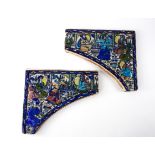 A PAIR OF QAJAR POTTERY TILE SPANDRELS (2)