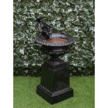 A 19TH CENTURY BLACK PAINTED CAST-IRON URN WITH CHERUB MOUNT