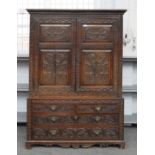 AN EARLY 19TH CENTURY CARVED OAK LINEN PRESS