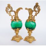 A PAIR OF FRENCH GILT SPELTER MOUNTED GREEN GLASS ORNAMENTAL EWERS (2)