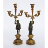 A PAIR OF FRENCH LOUIS-PHILIPPE GILT AND PATINATED BRONZE THREE-LIGHT FIGURAL CANDELABRA (2)