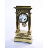 A FRENCH EMPIRE STYLE POLISHED BRASS PORTICO CLOCK