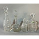 THREE 20TH CENTURY GLASS DECANTERS AND STOPPERS, AND A CUT GLASS EWER.