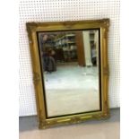 A MODERN GOLD PAINTED RECTANGULAR WALL MIRROR