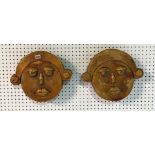 A PAIR OF GOLD PAINTED CARVED WOOD FACES, (2)