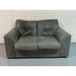 A MODERN SAGE GREEN LEATHER UPHOLSTERED TWO SEAT SOFA