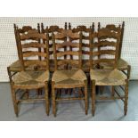 A SET OF SEVEN EARLY 20TH CENTURY PINE LADDER BACK DINING CHAIRS (7)