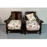 A PAIR OF EARLY 20TH CENTURY STAINED BEECH AND CANEWORK LOW ARMCHAIRS