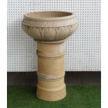 A TERRACOTTA CHIMNEY POT WITH ASSOCIATED CIRCULAR JARDINIERE