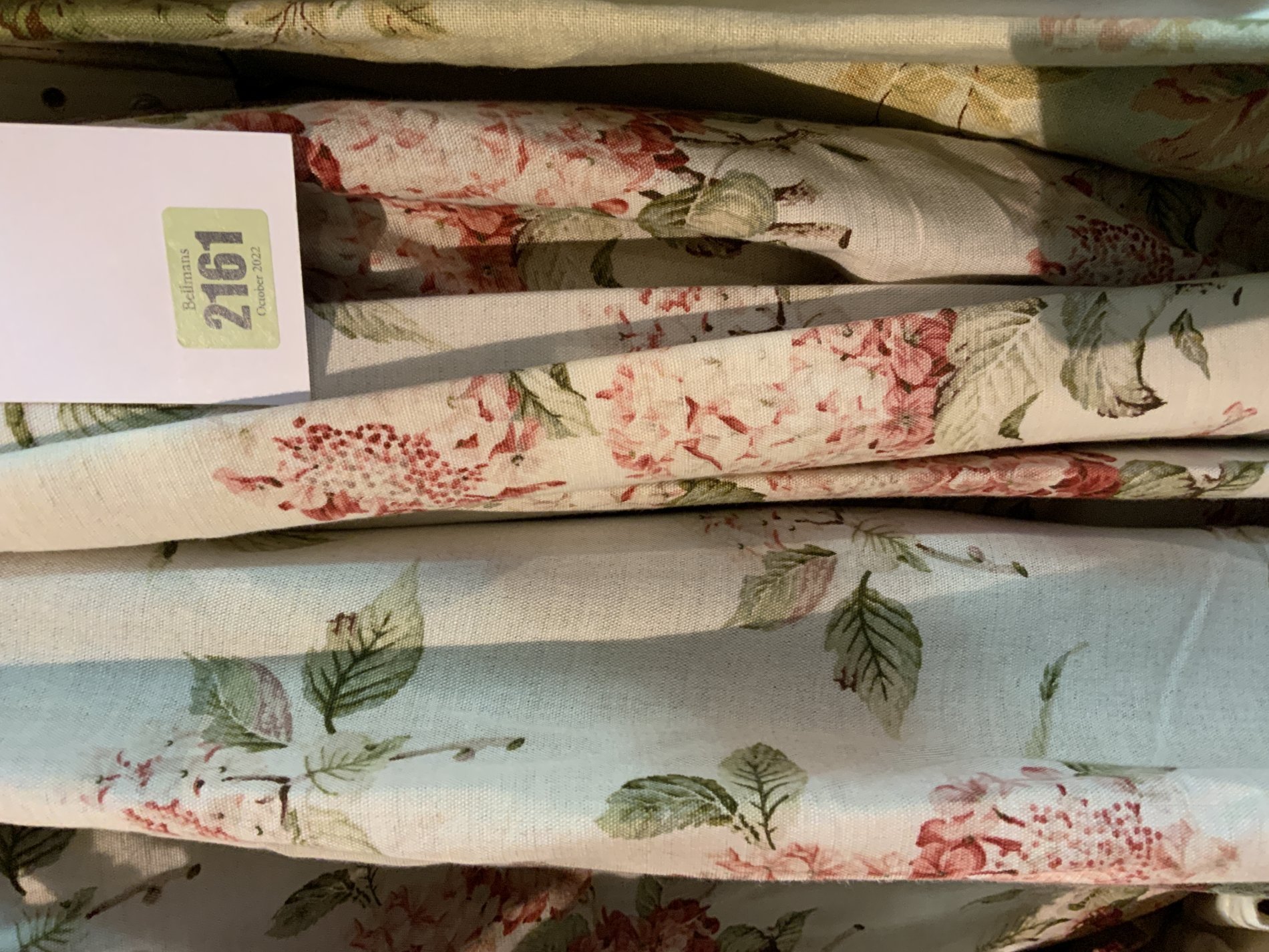 A SET OF FIVE LINED AND INTERLINED FLORAL CURTAINS