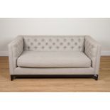 REVAMPINTERIORS.CO.UK, A GREY UPHOLSTERED BUTTON BACK SOFA ON EBONISED SUPPORTS