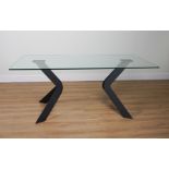 A GLASS RECTANGULAR DINING TABLE