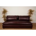 A LARGE BROWN LEATHER SOFA