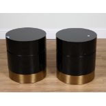 A PAIR OF BLACK LACQUER AND BRASS CYLINDRICAL BEDSIDE TABLES (2)