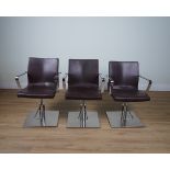 SALON AMBIENCE, A SET OF SIX CHROME AND LEATHER REVOLVING OPEN ARMCHAIRS (6)
