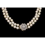 A CULTURED PEARL NECKLACE WITH DIAMOND SET CLASP