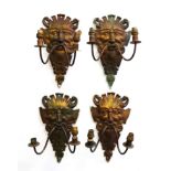 A SET OF FOUR GILT-METAL SATYR MASK TWIN-LIGHT WALL APPLIQUES (4)