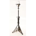 A BLACK PAINTED WROUGHT IRON FLOOR STANDING LAMP