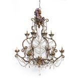 AN ITALIAN GILTWOOD AND GILT-METAL TWELVE LIGHT GLASS MOUNTED CHANDELIER