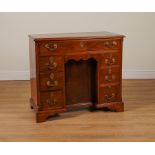 AN 18TH CENTURY MAHOGANY KNEEHOLE WRITING DESK WITH SEVEN DRAWERS ABOUT THE CUPBOARD