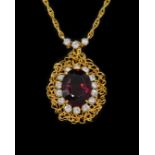A GARNET AND DIAMOND CLUSTER PENDANT NECKLACE
