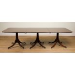 A REGENCY STYLE MAHOGANY TRIPLE PEDESTAL MAHOGANY EXTENDING DINING TABLE