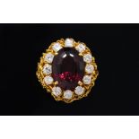 A GARNET AND DIAMOND CLUSTER RING