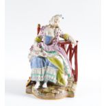 A MEISSEN FIGURE OF A SEATED WOMAN