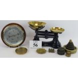 A set of traditional style kitchen scales with various weights, an Aneroid barometer, and three