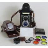 A Rolleiflex T model 1 TLR camera with 75mm F3.5 Zeiss lenses, leather case, filters and