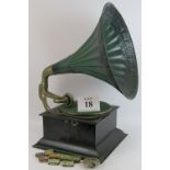 A vintage wind up gramophone with steel horn and oak case plus 7 tins of needles and a spare head.