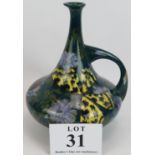 A Rozenburg Den Haag Pottery ewer decorated with butterflies and flowers. Marked to base model No