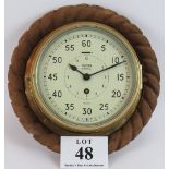 A vintage Smith's astral ships clock No AP160174 mounted on a wooden plaque with carved rope twist