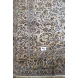 A fine Persian Kashan carpet heavily patterned (foliage) on a cream ground in good condition