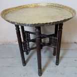 A vintage brass Benares table, the dished top with piecrust edge depicting figural scenes of ancient