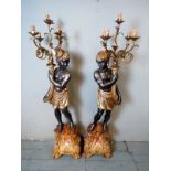 A pair of vintage plaster on limewood blackamoor candelabra floor standing lamps in the form of a