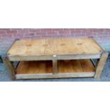 A vintage light oak two-tier coffee table with planked beech top featuring mahogany ties raised on
